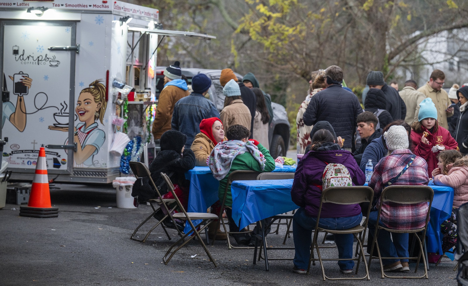 Families eating at iDrips Coffee Co. food truck tables